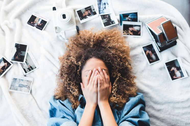 Woman surrounded by photos to show how to use Instagram for business.